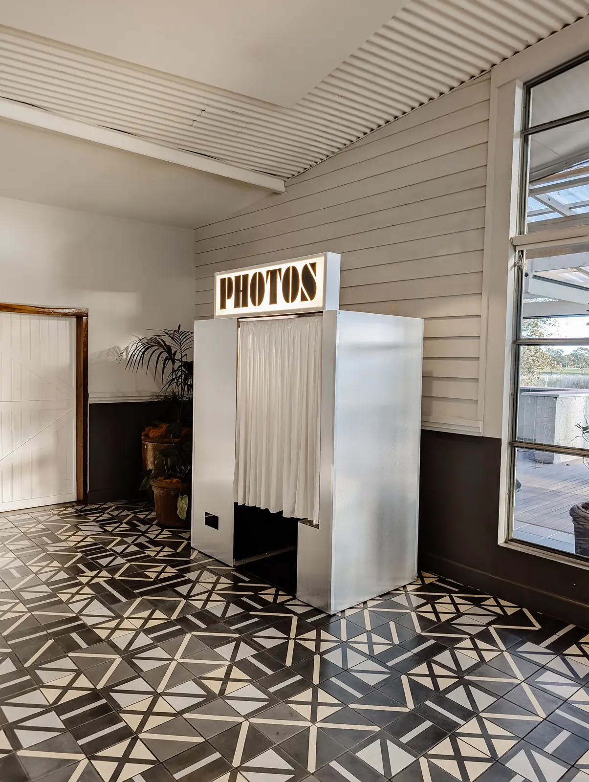 The Futura Lux vintage booth in a white room on a patterned tile floor